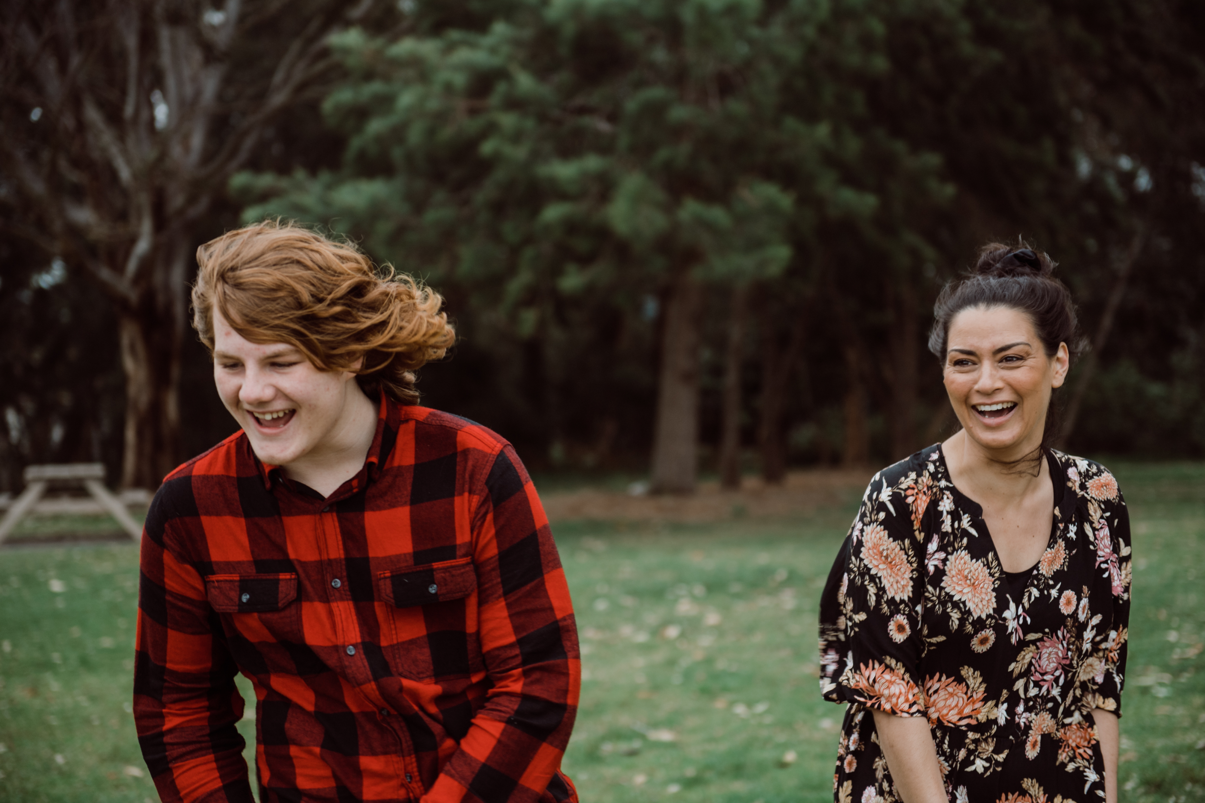 Harry and Amber in a park laughing